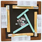Top view of the AURAJONG R1 automatic American Mahjong table during play with tiles, Sightline Racks, and NMJL cards