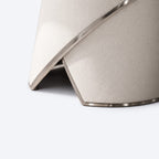 Close-up detail of the AURAJONG S4 automatic American Mahjong table base in ivory upholstery with metal trim.