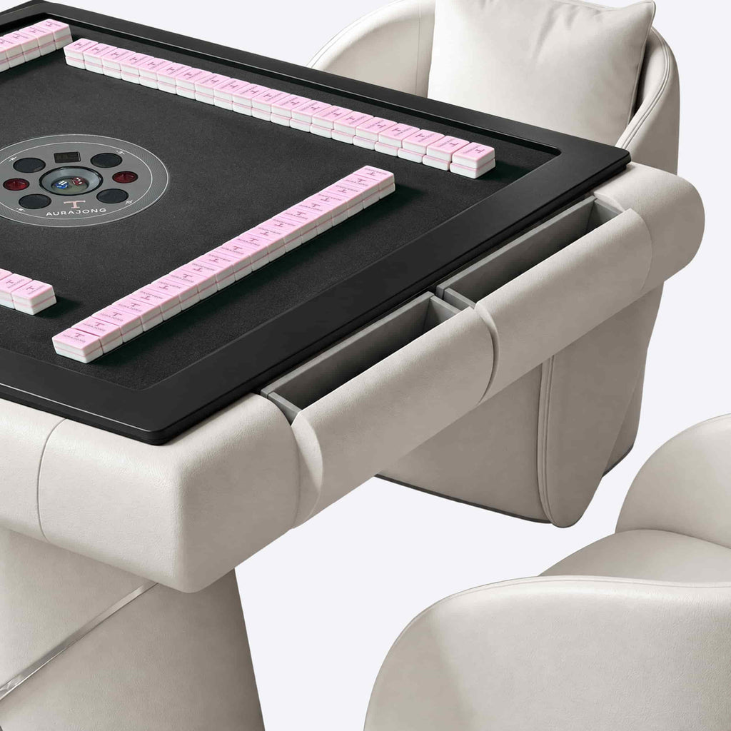 Detail view of the AURAJONG S4 automatic American Mahjong table drawers in ivory with grey play surface and pink tiles.