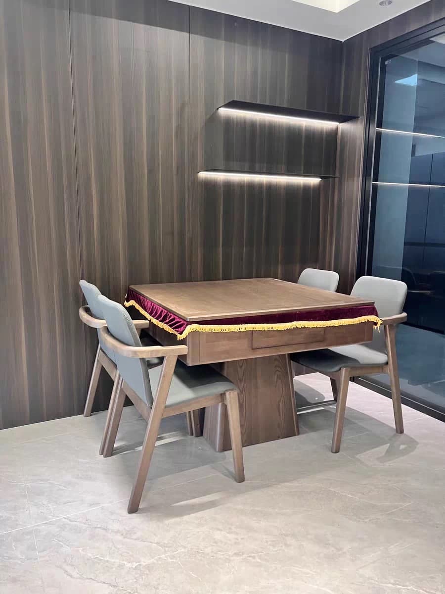 AURAJONG R1 automatic American Mahjong table in a modern home interior with walnut finish and four upholstered chairs