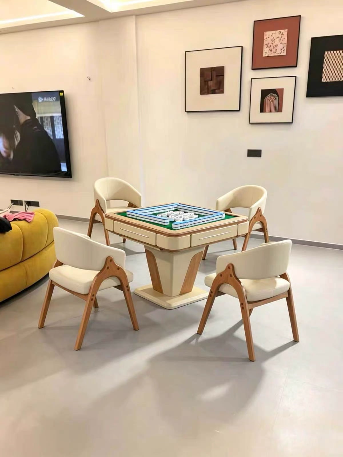 AURAJONG R2 automatic American Mahjong table with green play surface in a modern living room with four upholstered chairs