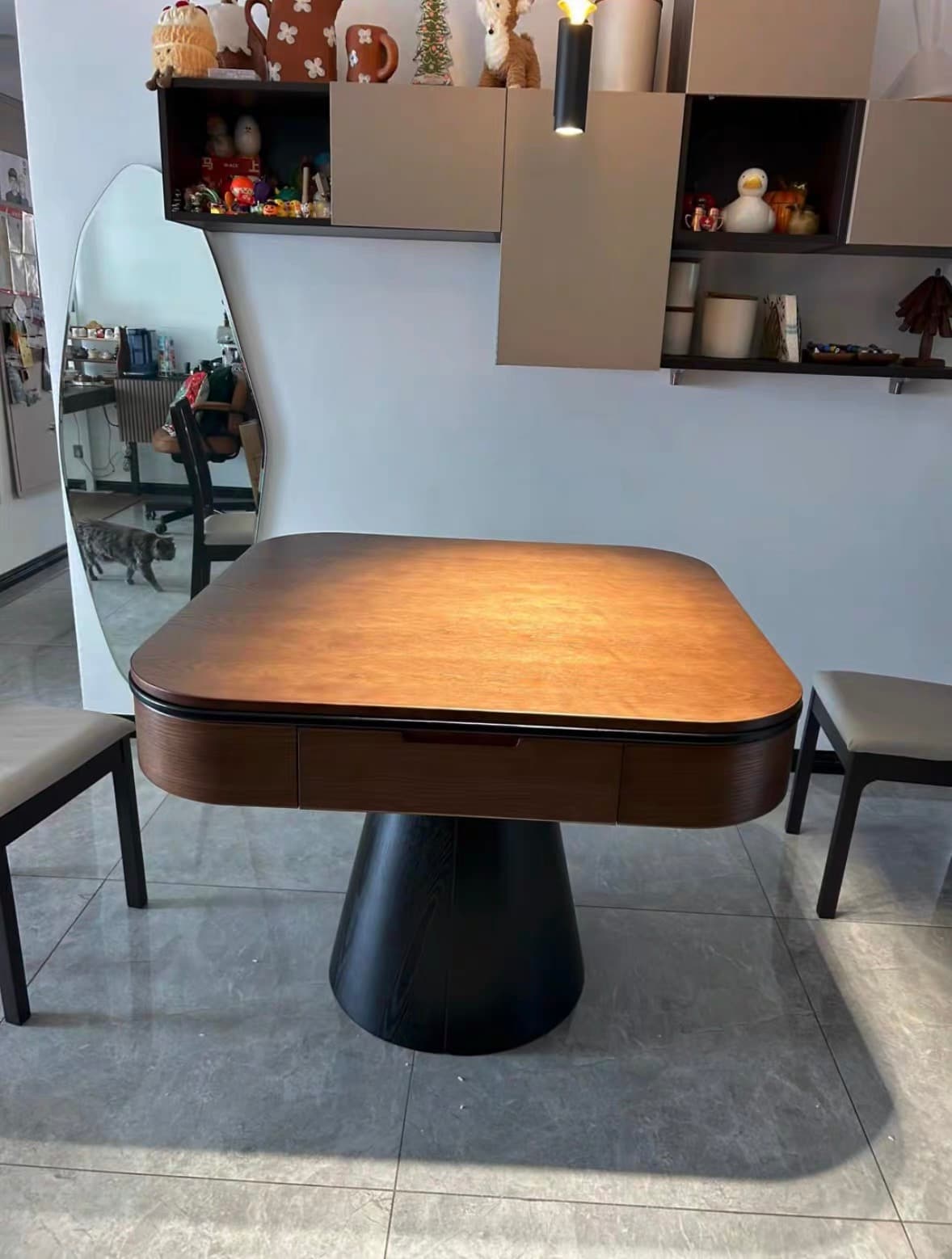 AURAJONG R5 automatic American Mahjong table with walnut top and black sculptural pedestal base in a contemporary home interior