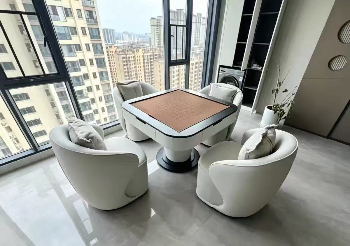 AURAJONG S1 automatic American Mahjong table with brown play surface and four ivory lounge chairs in a high-rise home interior