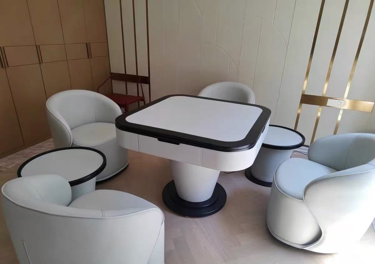 AURAJONG S1 automatic American Mahjong table with ivory finish, black trim, matching side tables, and four upholstered lounge chairs