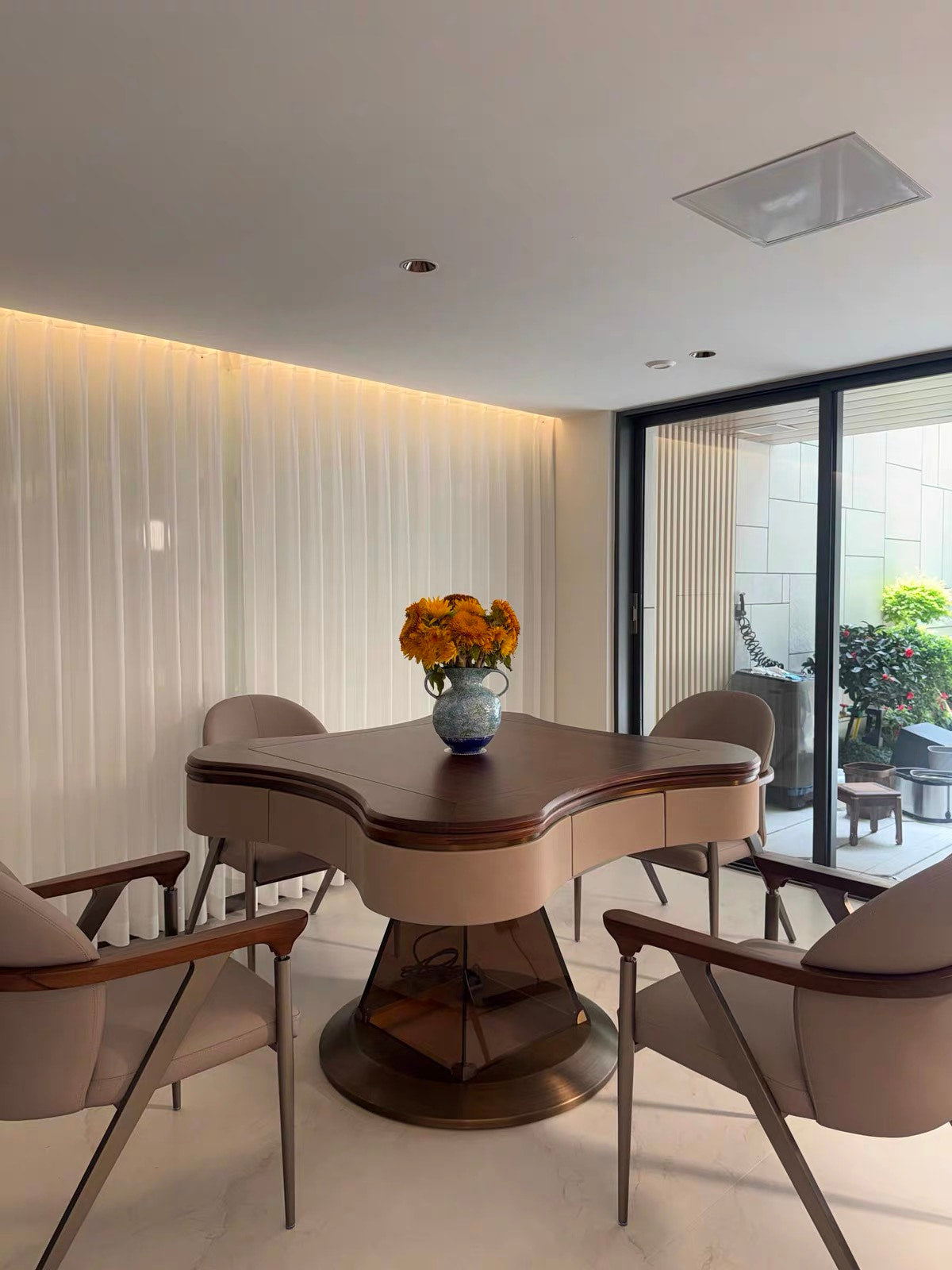 AURAJONG S2 automatic American Mahjong table with dining cover in a modern home interior with four upholstered chairs