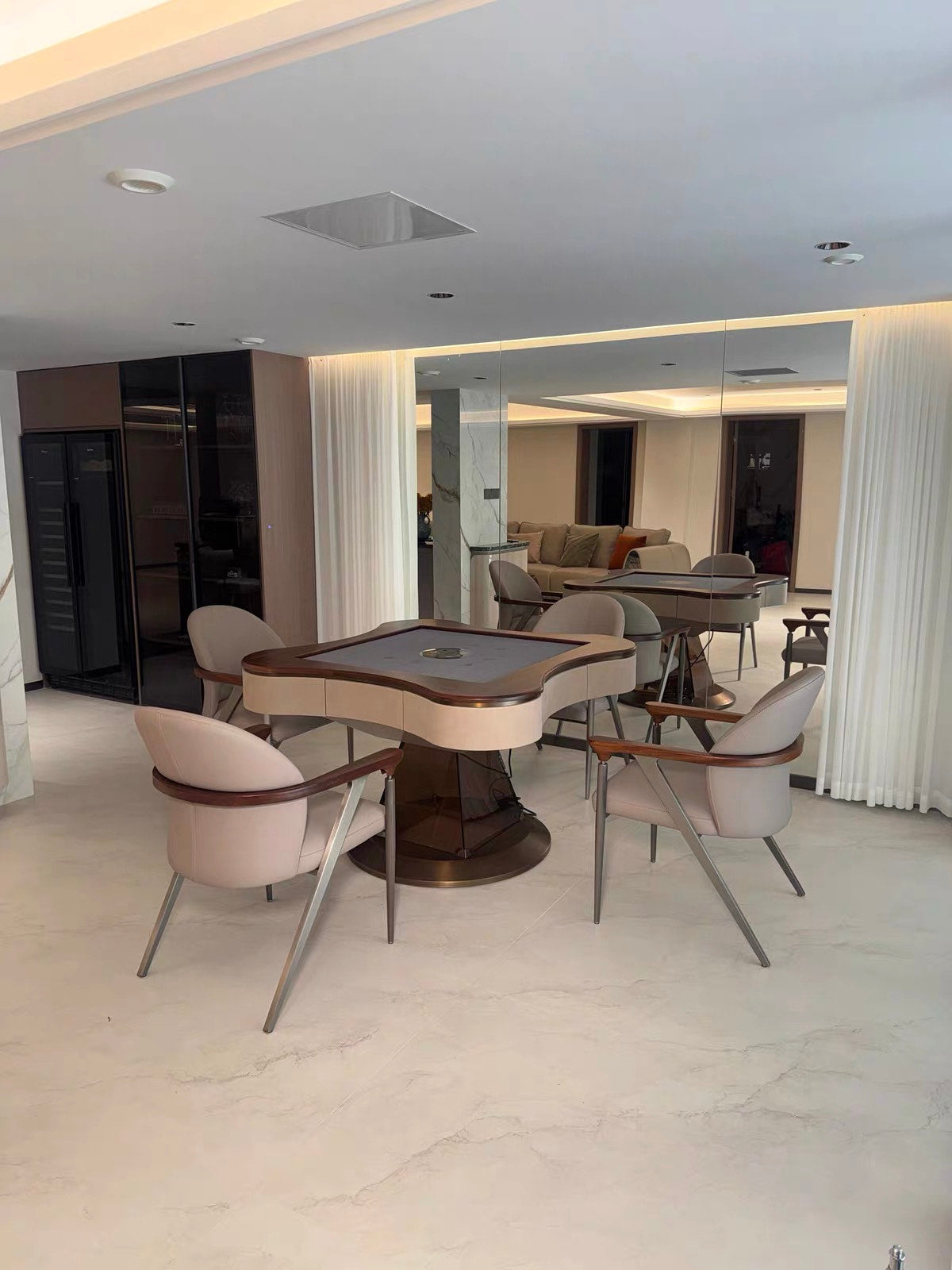 AURAJONG S2 automatic American Mahjong table with grey play surface in a luxury modern interior with four upholstered chairs