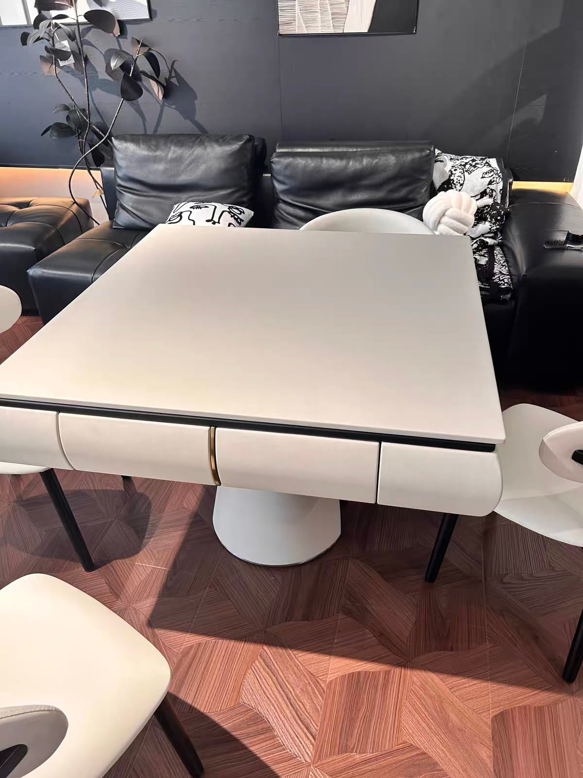 AURAJONG S4 automatic American Mahjong table with closed top in a luxury modern interior with sculptural ivory seating and a light cool-toned setting