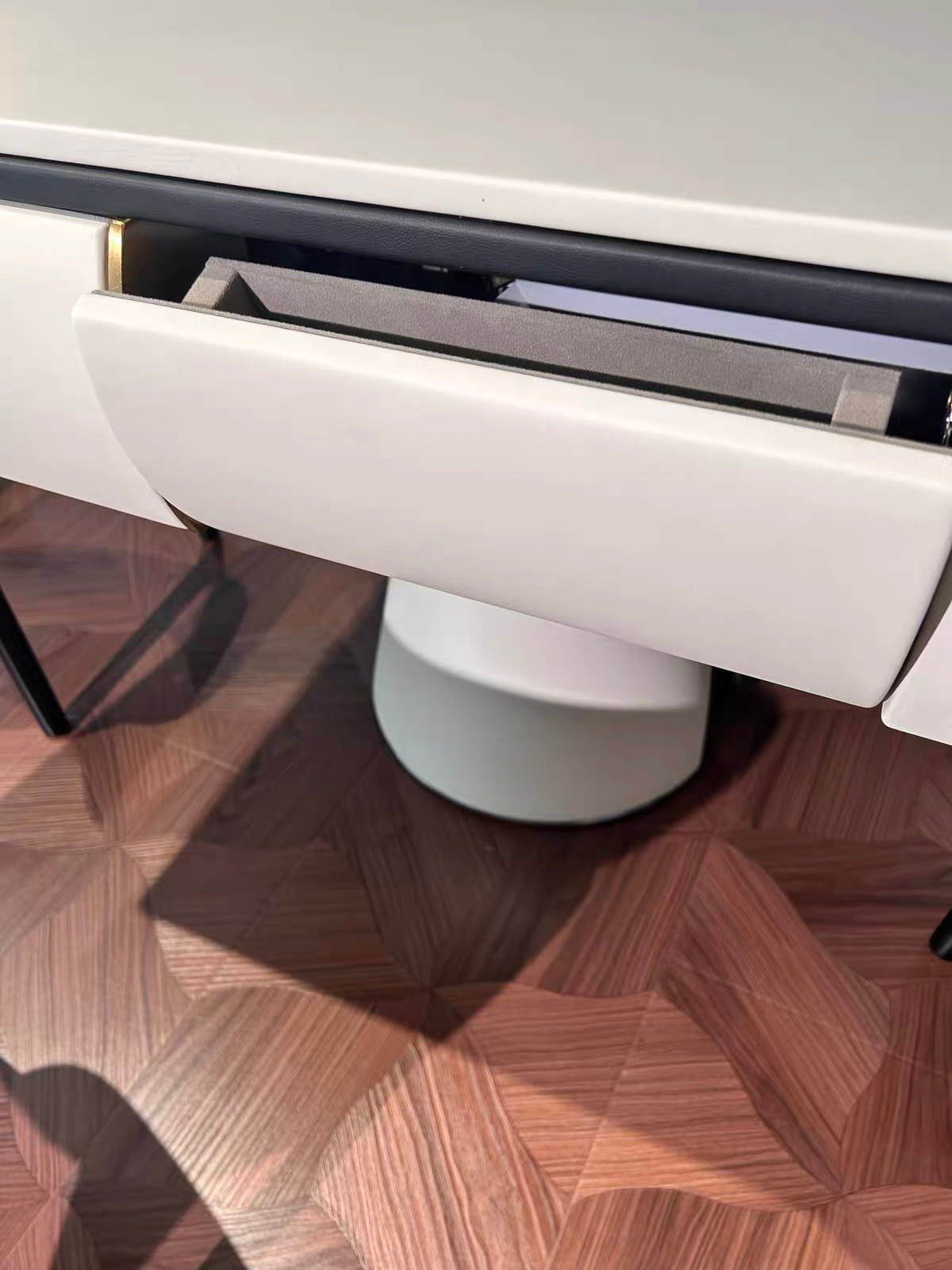 Detail view of the AURAJONG S4 automatic American Mahjong table showing the built-in storage drawer in a refined modern interior